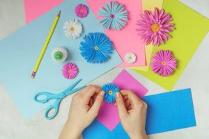 Making paper flowers art. DIY concept. Pastel colors, flat lay.